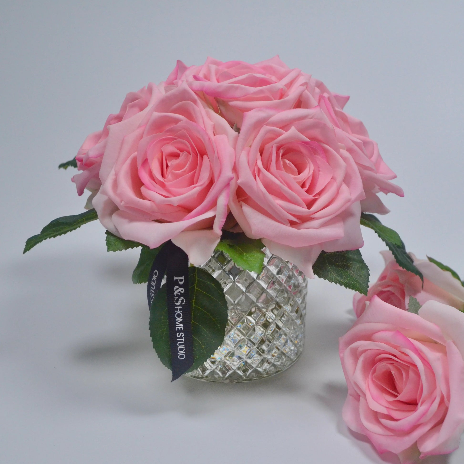 Bouquet of pink roses in a decorative vase with a blurred background