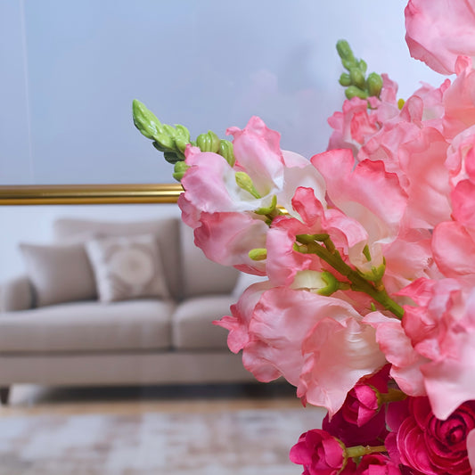 Close-up of pink flowers with a blurred background of a living room.