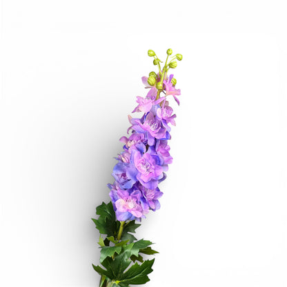 Artificial flower arrangement with purple and green elements on a white background