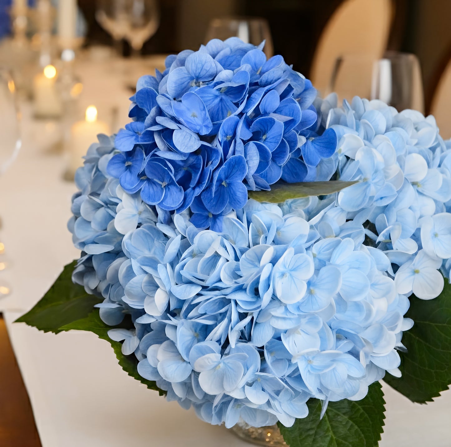 Blue hydrangea flower arrangement on a table with blurred background