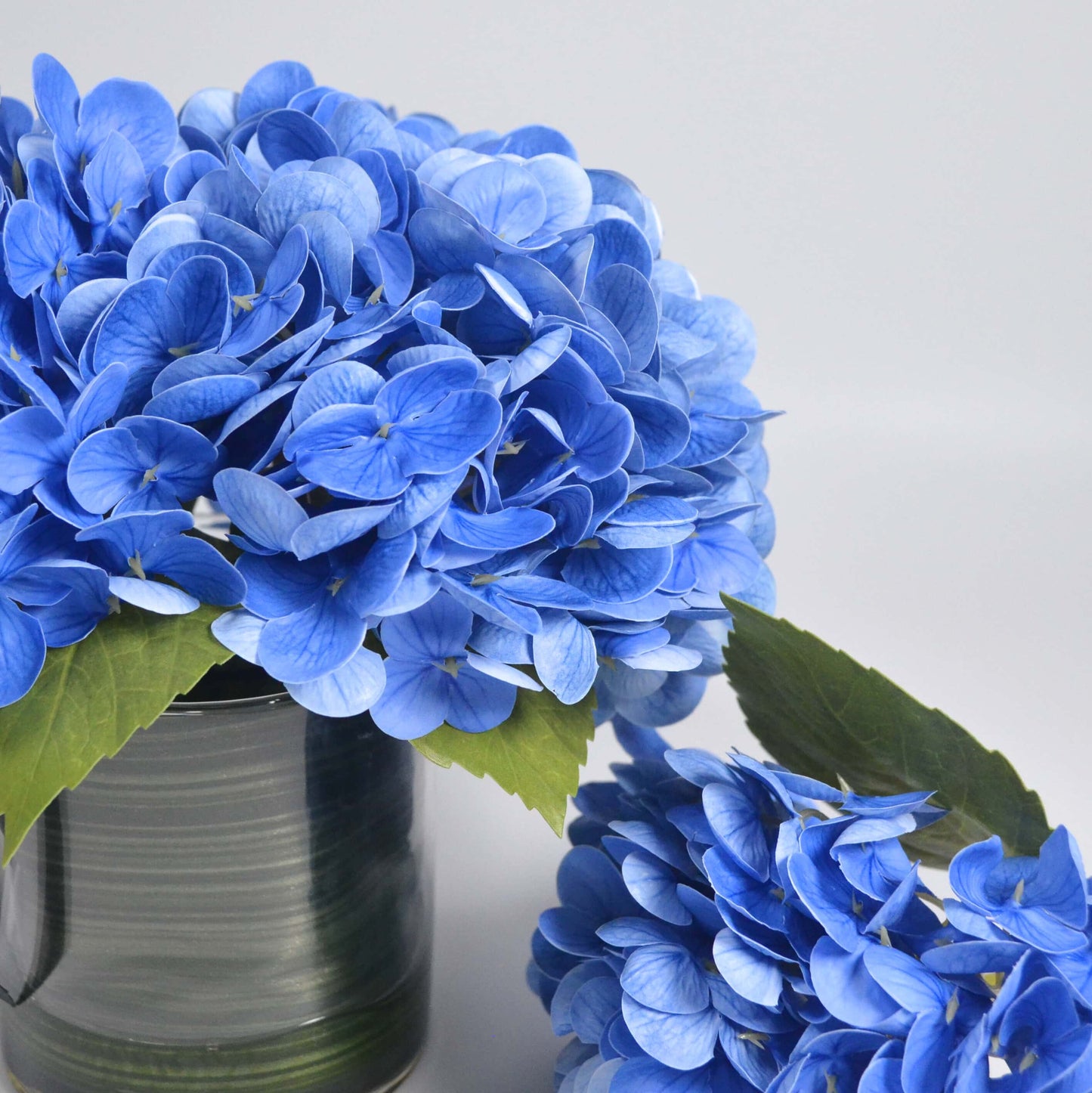 Blue hydrangea in glass vase faux floral