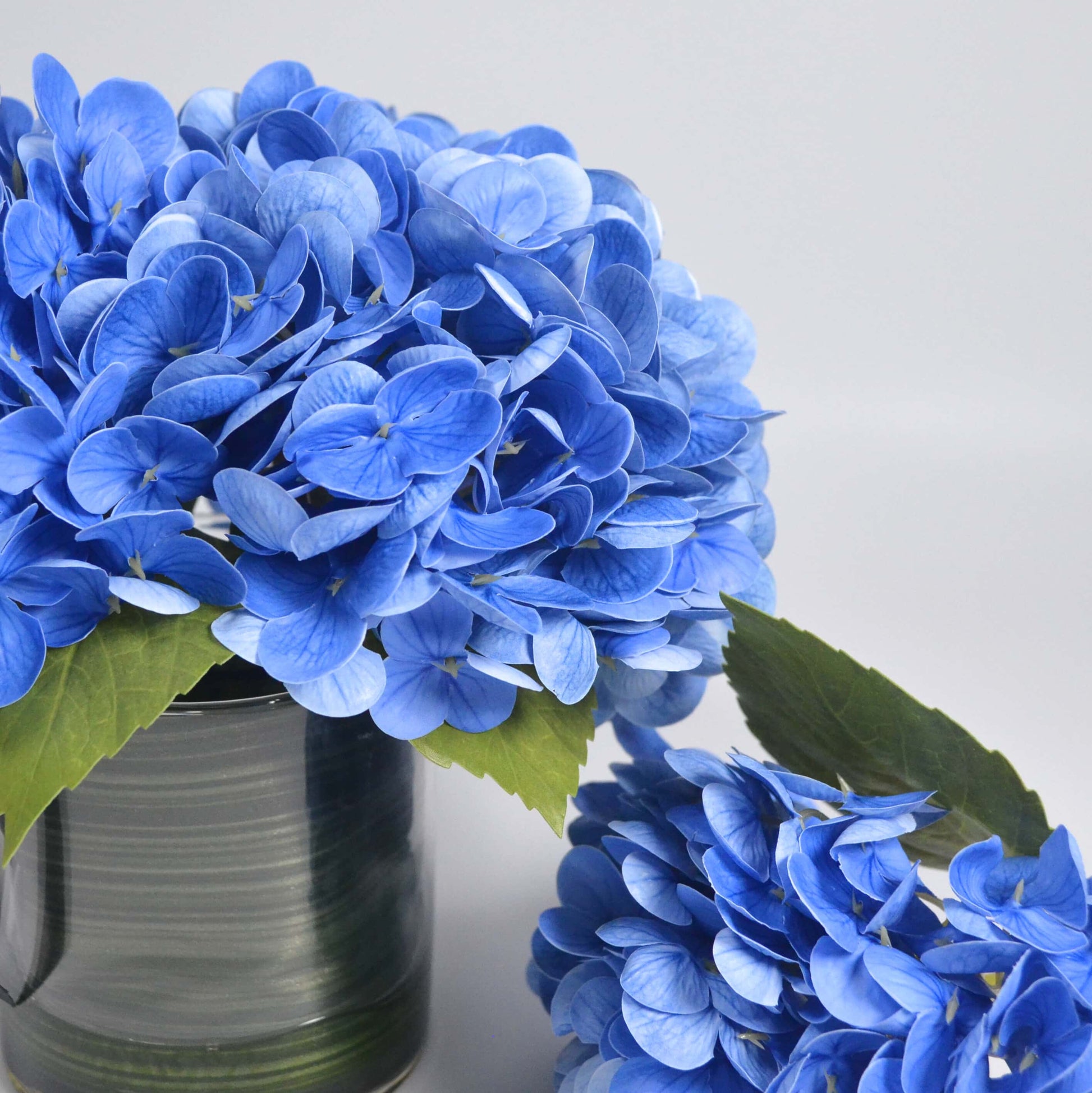 Blue hydrangea in glass vase faux floral
