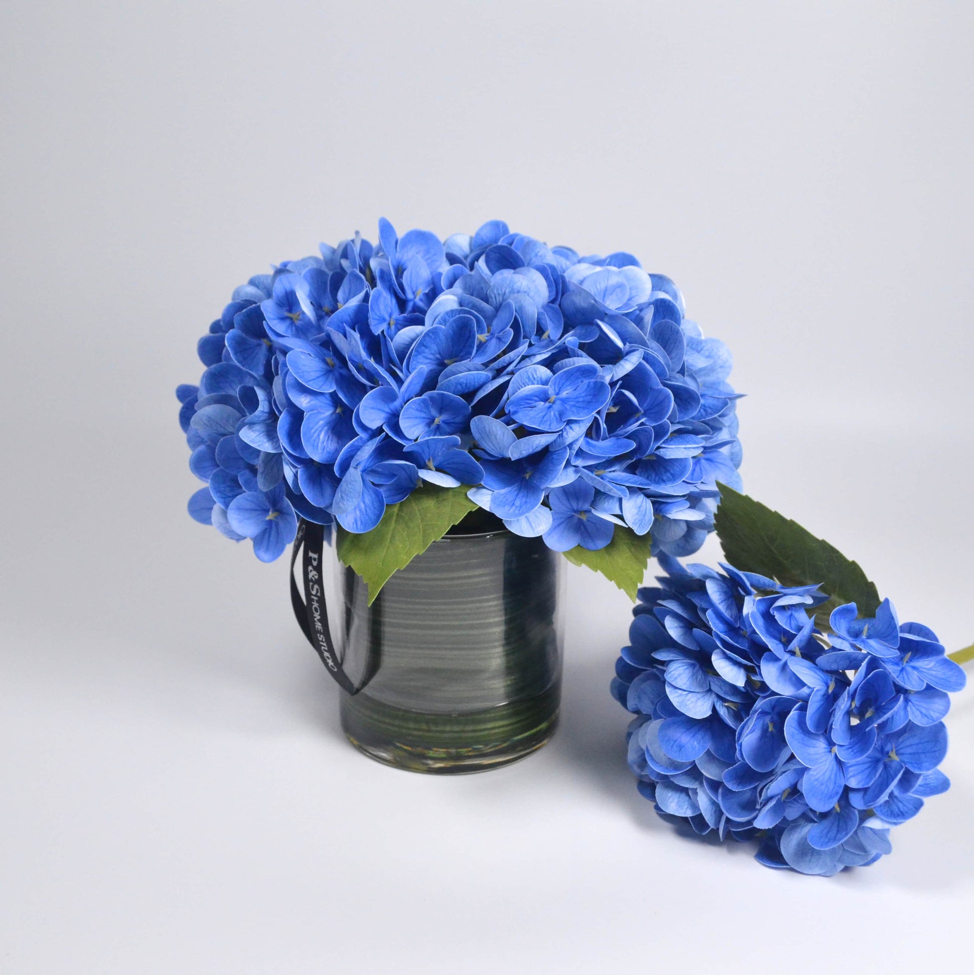 Blue hydrangea in glass vase faux floral