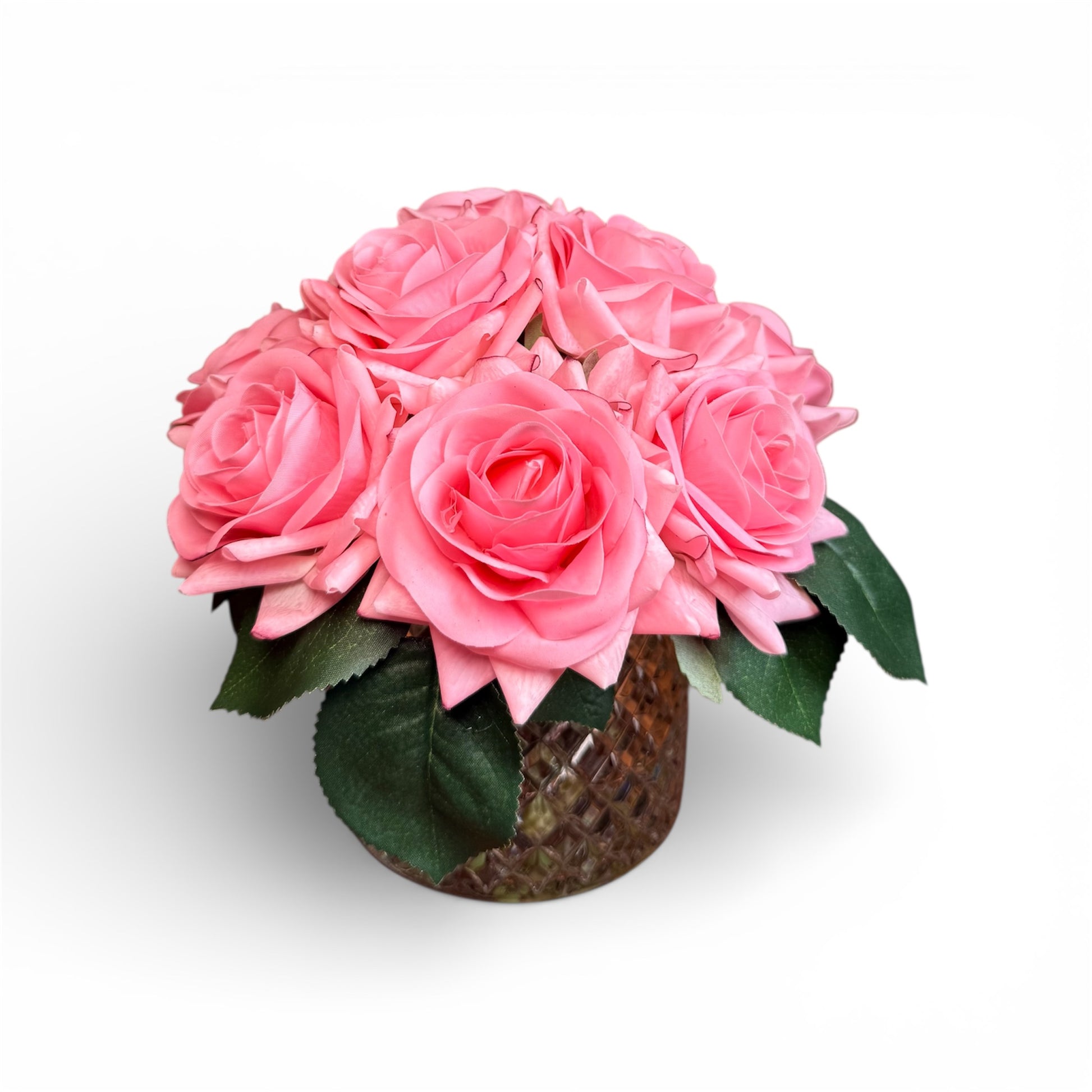 Bouquet of pink roses in a clear vase on a white background