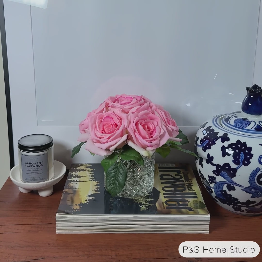 Bouquet of pink roses with green leaves on a light gray background