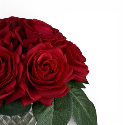 Bouquet of red roses with green leaves on a white background