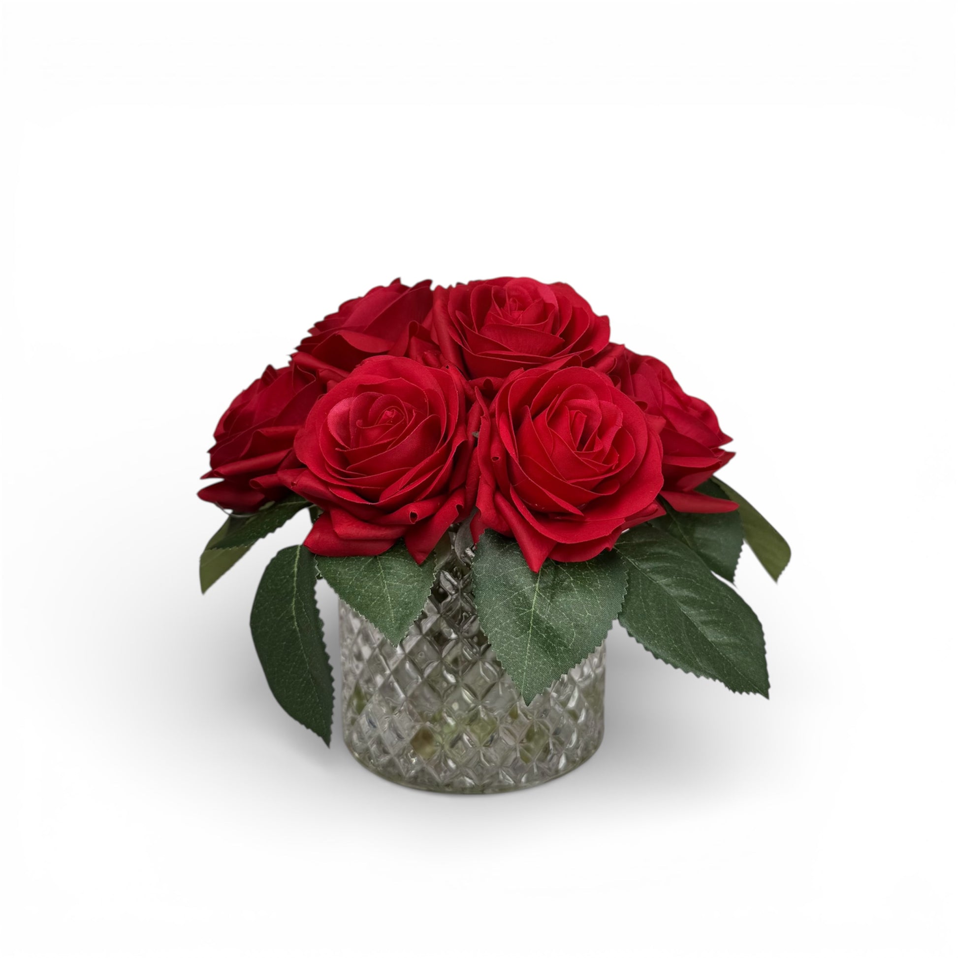Bouquet of red roses in a decorative glass vase on a white background